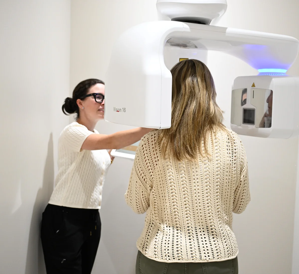 Team member positioning a patient in the Vision 16 cone beam CT scanner at Smile Spot Dentistry, Venice FL