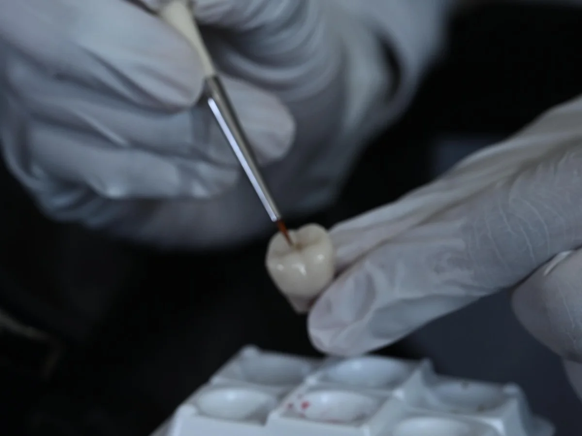 Master ceramist finishing a ceramic crown — Smile Spot Dentistry, Venice FL