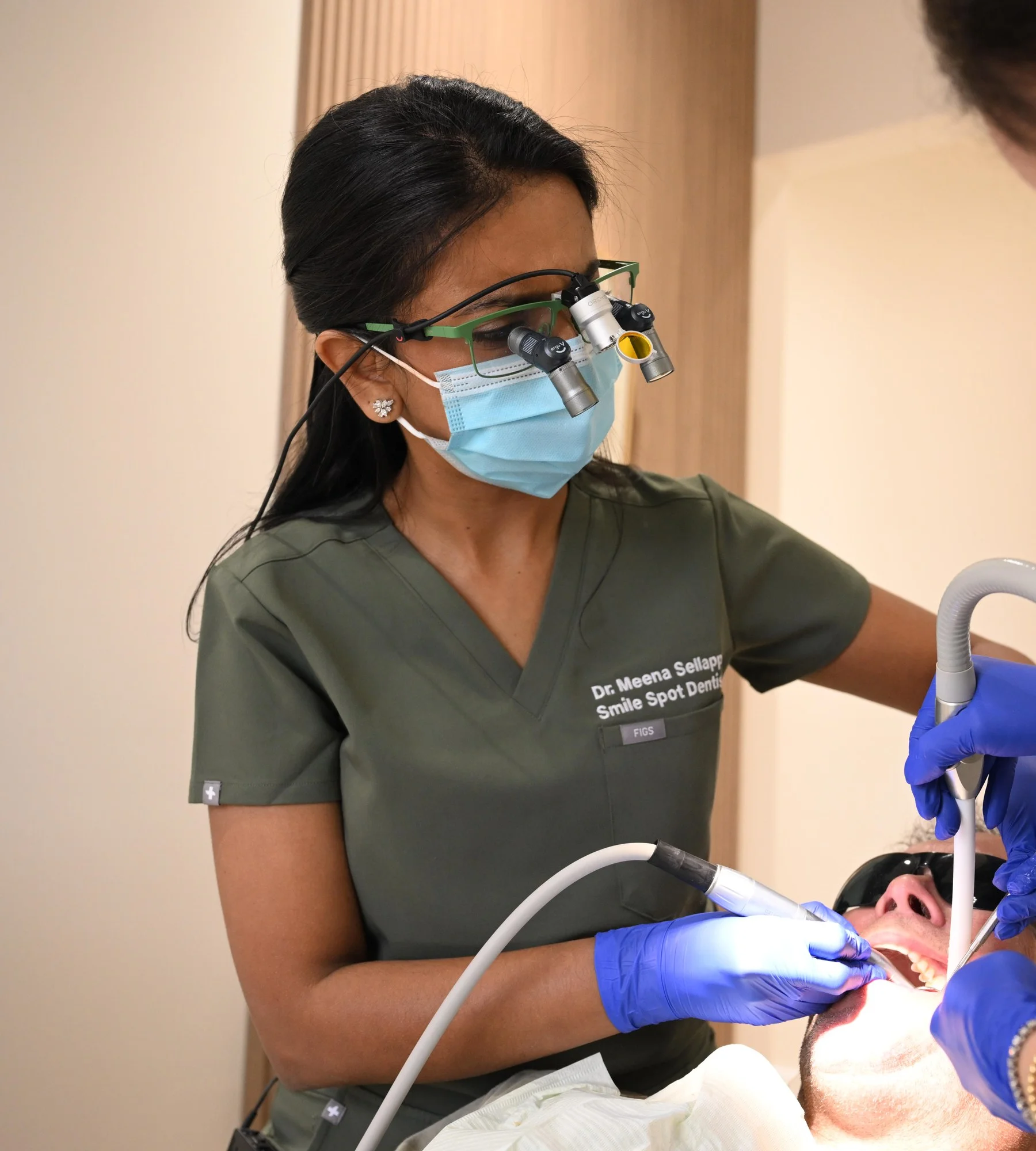 Dr. Meenachi Sellappan placing a dental implant — Smile Spot Dentistry, Venice, FL