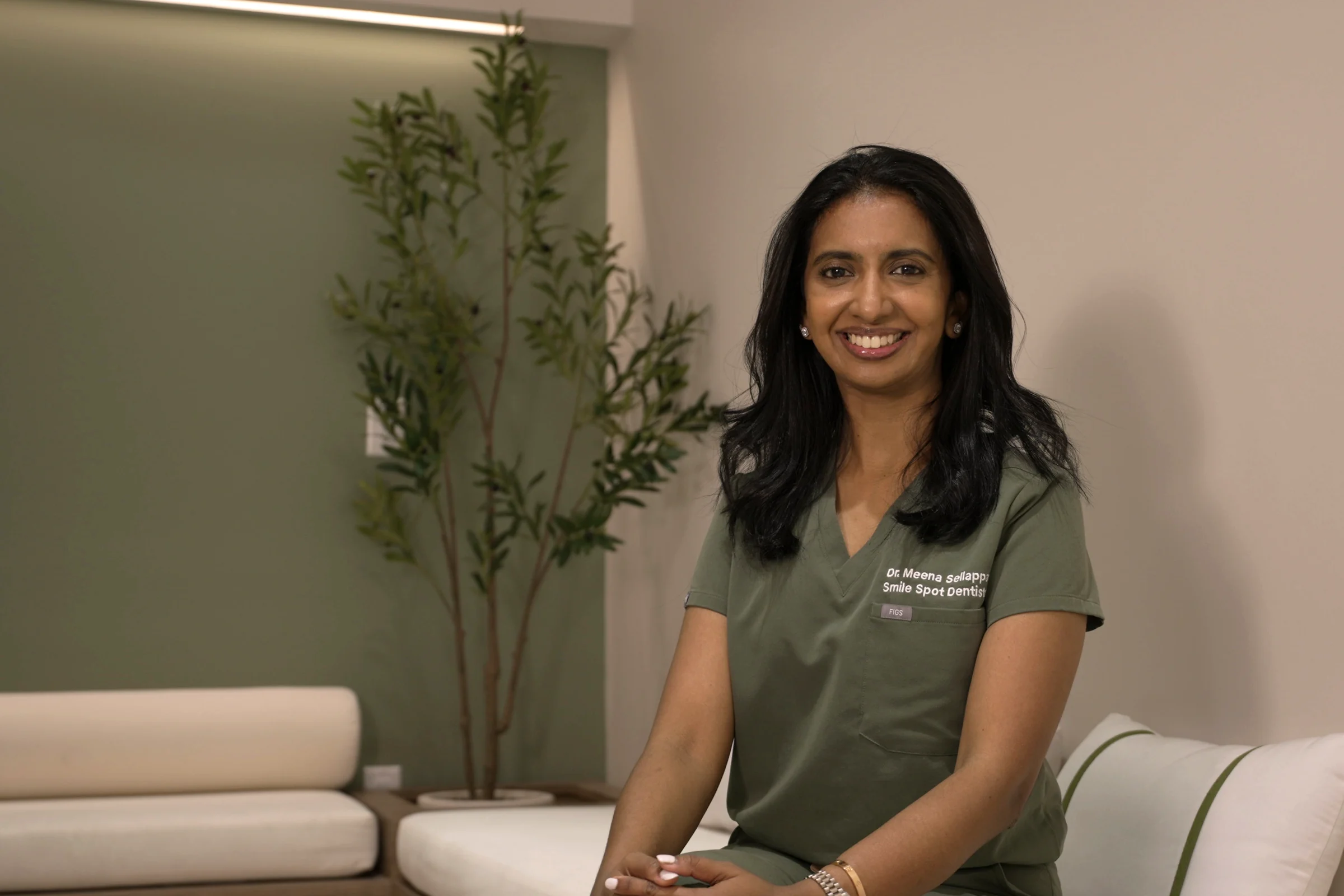 Dr. Meenachi Sellappan DDS in Smile Spot scrubs in the lounge — Principal Dentist at Smile Spot Dentistry Venice FL