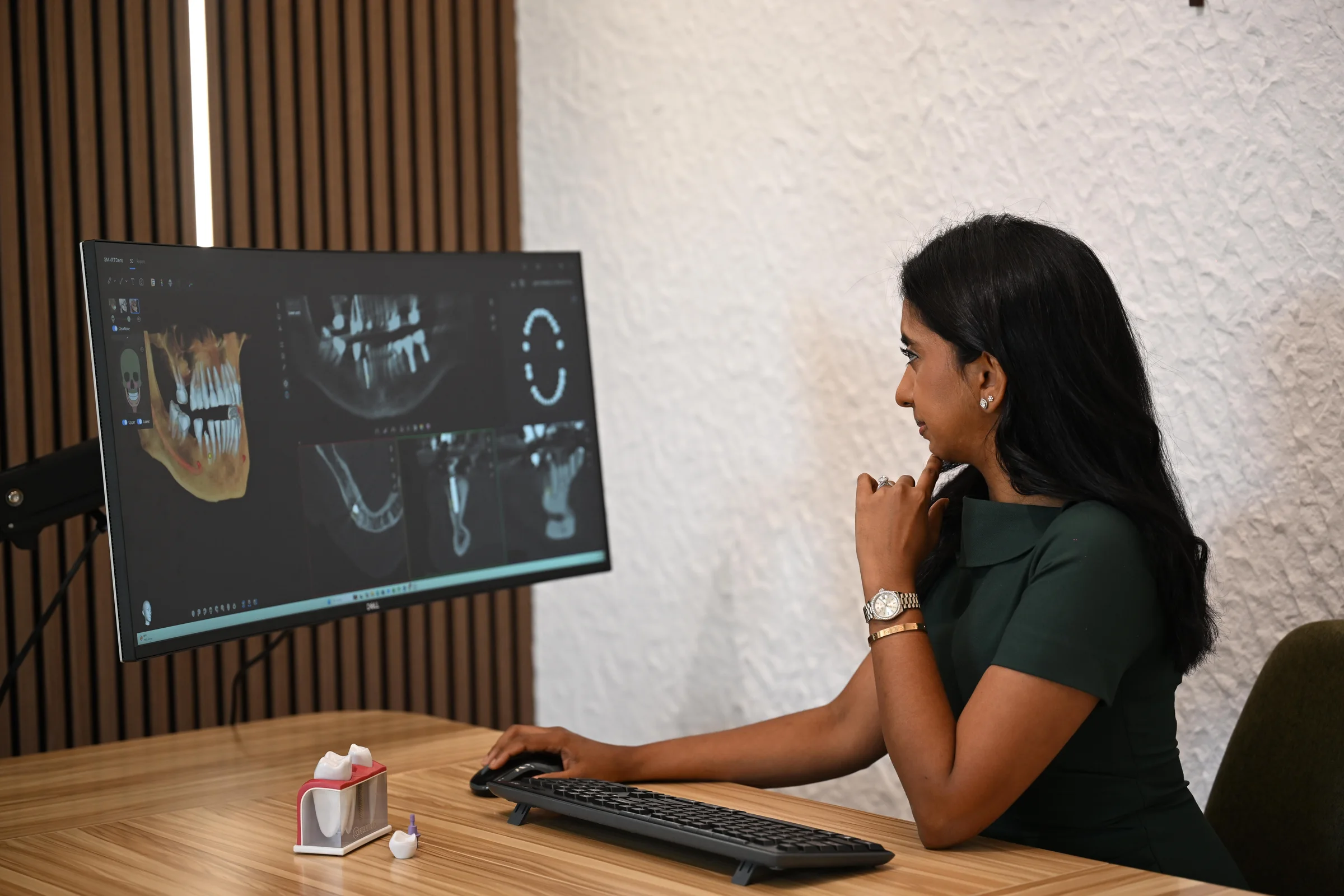 Dr. Meenachi Sellappan reviewing a CBCT implant plan — Smile Spot Dentistry, Venice, FL