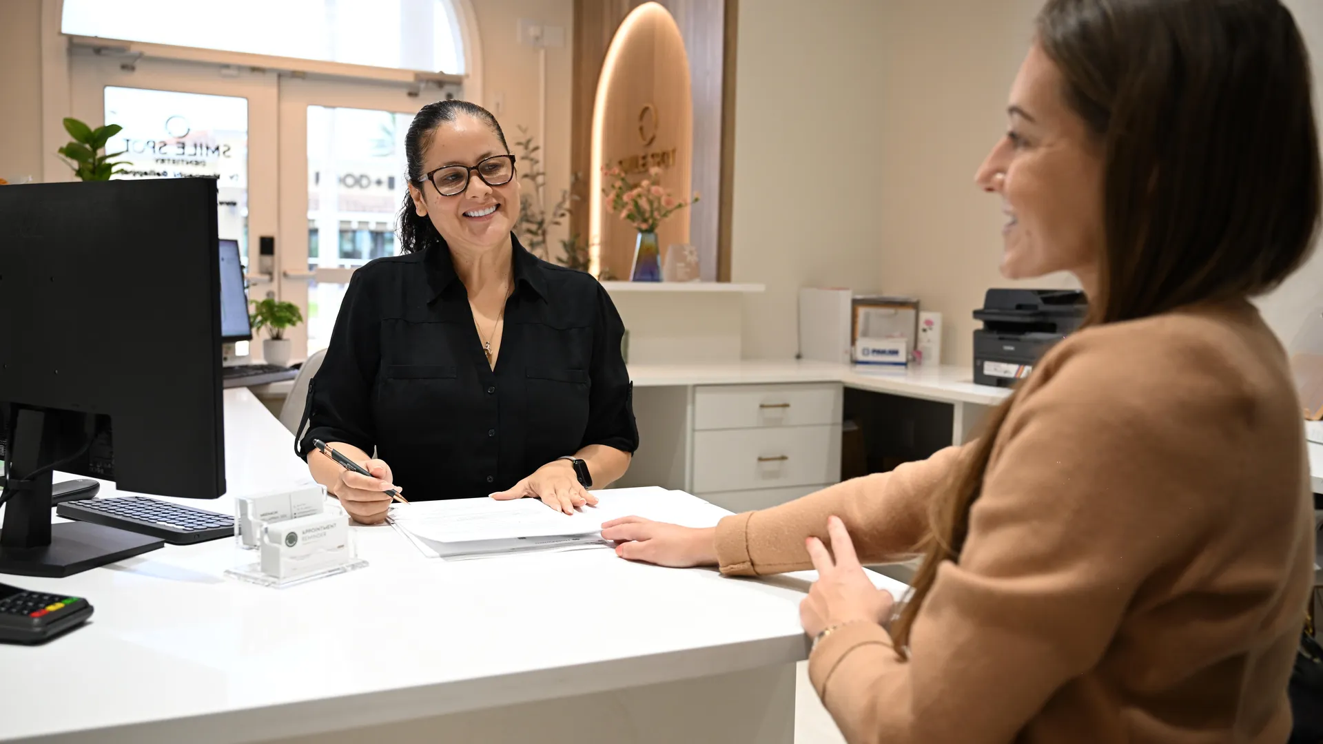 A patient and treatment coordinator reviewing options side by side at Smile Spot Dentistry, Venice FL
