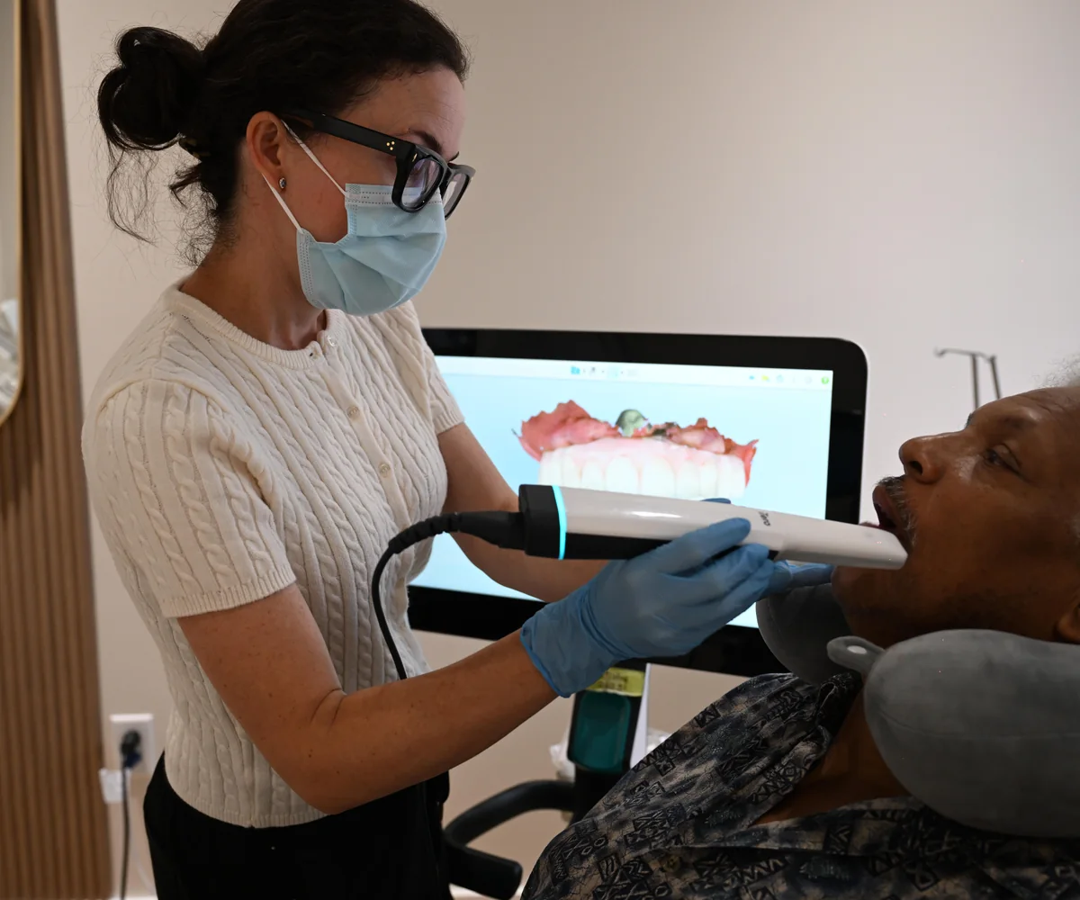 Dental assistant taking a digital iTero scan, with the 3D model on screen, at Smile Spot Dentistry, Venice FL
