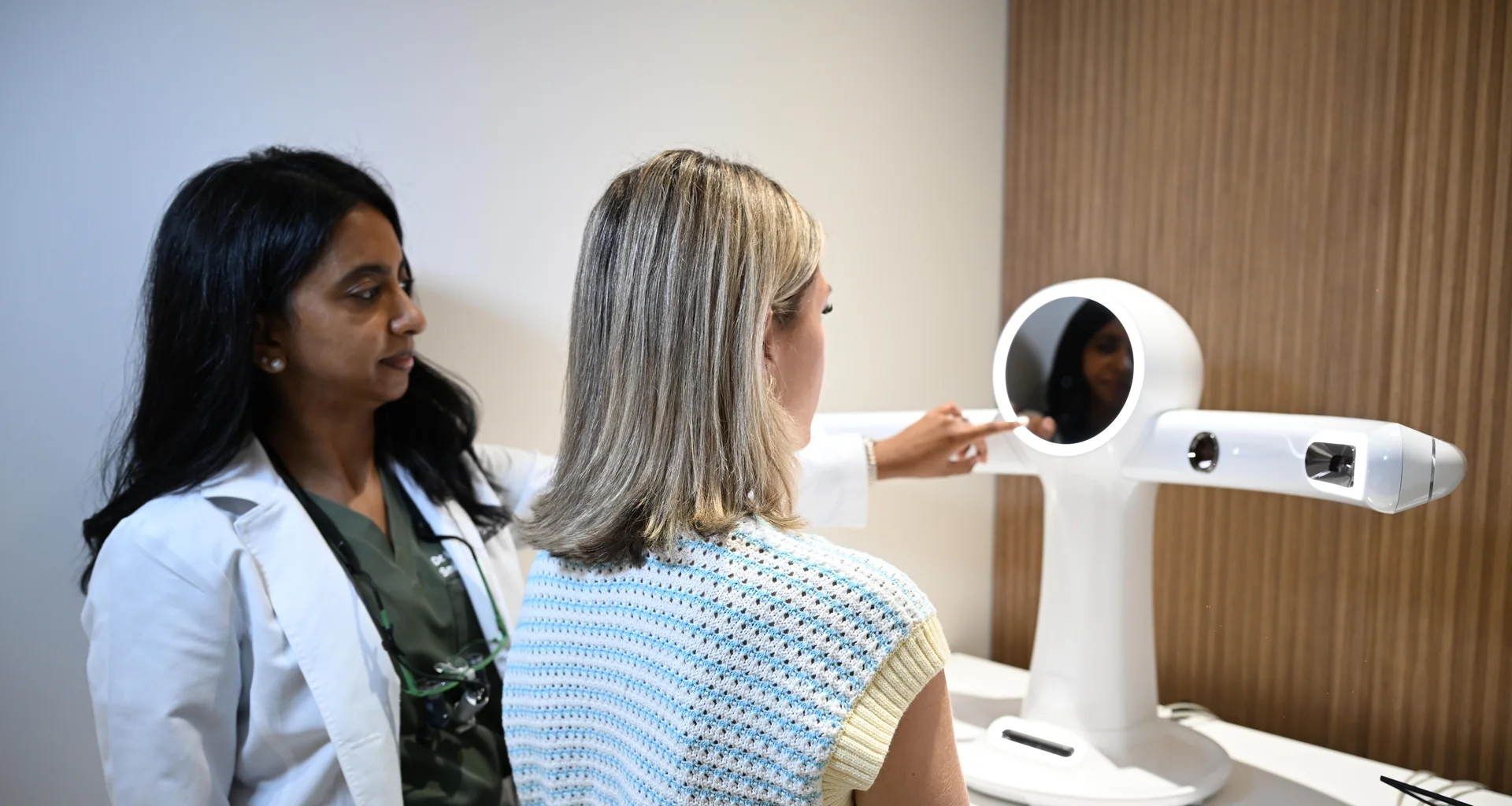 Dr. Sellappan guiding a patient through a RAYFace facial scan — Smile Spot Dentistry, Venice, FL