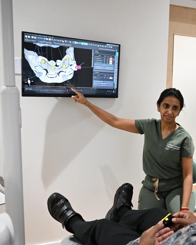 Dr. Sellappan reviewing the implant plan on the CBCT with the patient